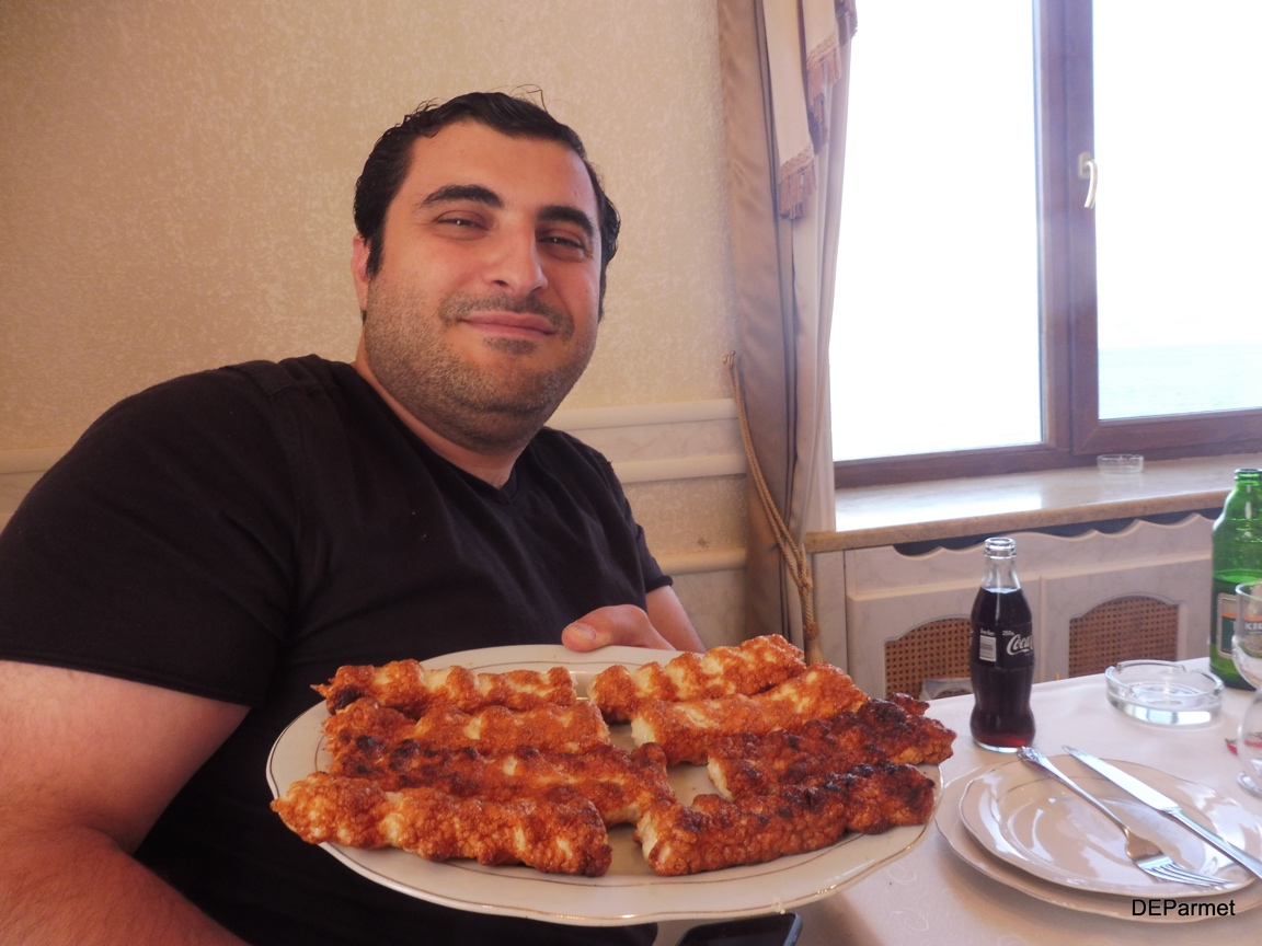 Sevan holding up Lake Sevan's lobster specialty cuisine that we are all about to enjoy.